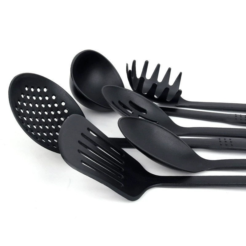 Set of 6 black heat-resistant plastic cooking utensils from Lavish Kitchen Isle, including spatulas and spoons, suitable for non-stick cookware.
