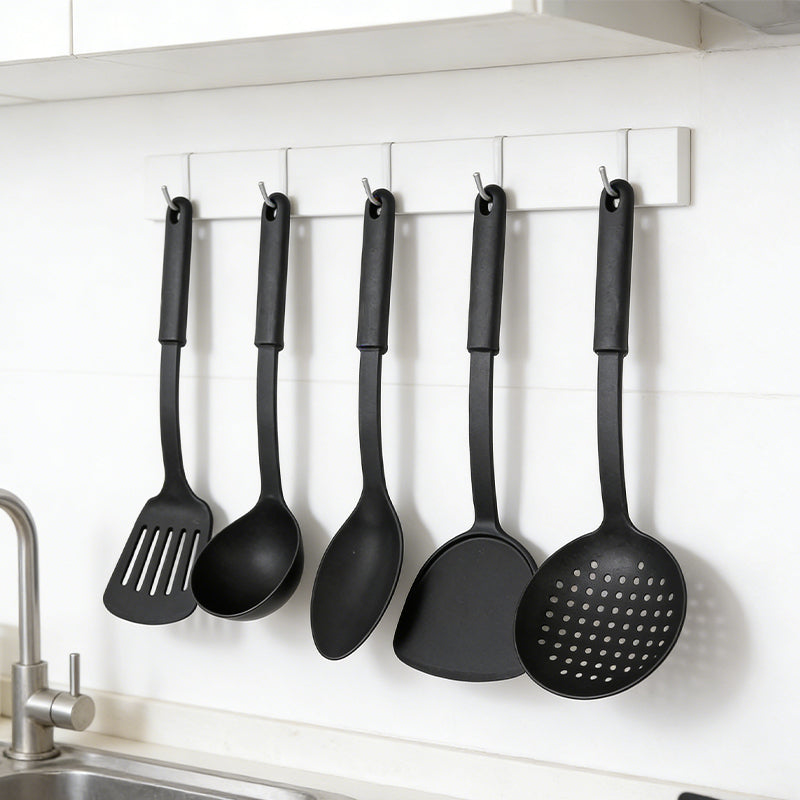 Set of six black heat resistant plastic cooking utensils from Lavish Kitchen Isle, including spatulas and spoons for versatile kitchen use.
