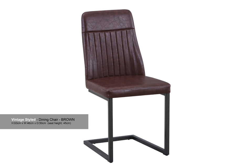 Pair of Baumhaus vintage grey and brown leather dining chairs with wooden legs, shown in a stylish modern dining room setting.