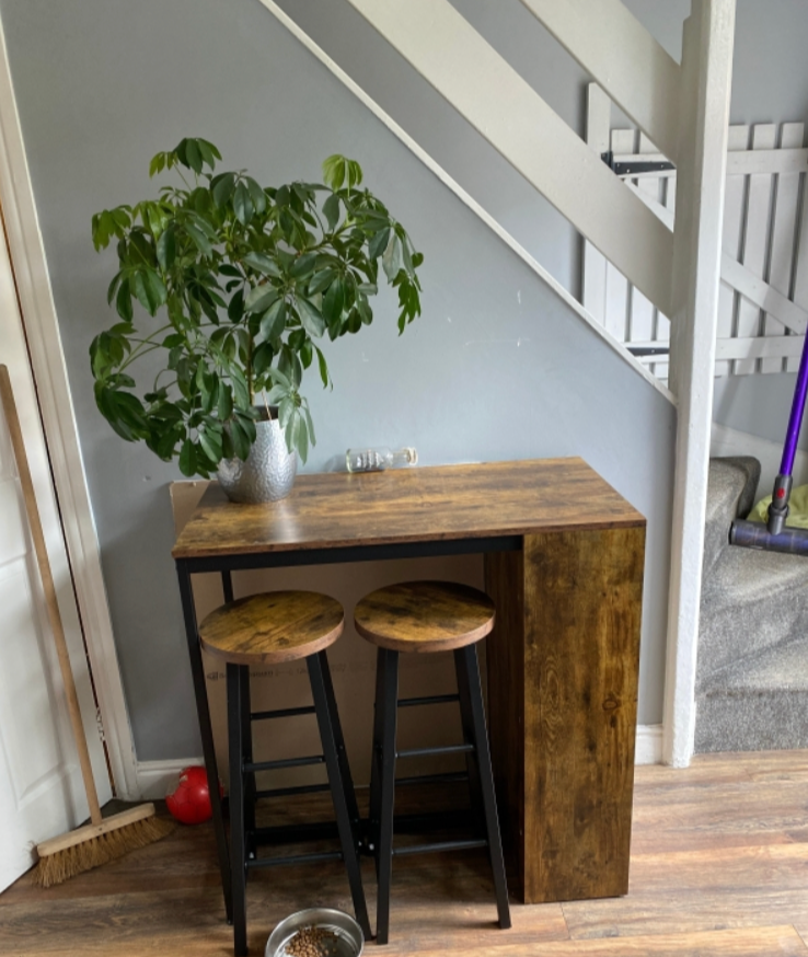 Industrial style bar table set by HOMCOM featuring a table with two stools and a storage shelf in a modern design.