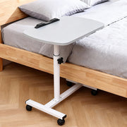 Grey adjustable overbed table tray with wheels, designed for home or medical use, featuring a spacious surface and mobility.