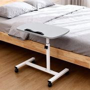 Grey adjustable overbed table tray with wheels, suitable for home or medical use, featuring a sleek design and sturdy construction.