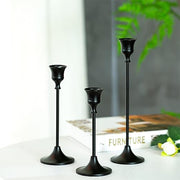Three decorative candlestick holders by Lavish Kitchen Isle, styled on a dining table for home decor elegance.
