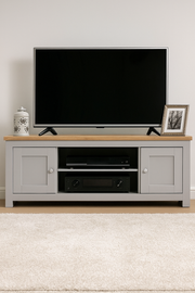 Modern light grey TV stand cabinet with two doors and storage compartments, ideal for contemporary living room furniture.