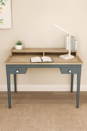 Baumhaus signature blue desk in a stylish setting, showcasing its elegant design and ample workspace.