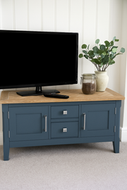 Baumhaus Signature Blue widescreen television stand with a stylish wooden design and spacious storage compartments.