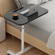 Black adjustable overbed table with wheels for home or medical use, featuring a sturdy surface and mobility for convenience.