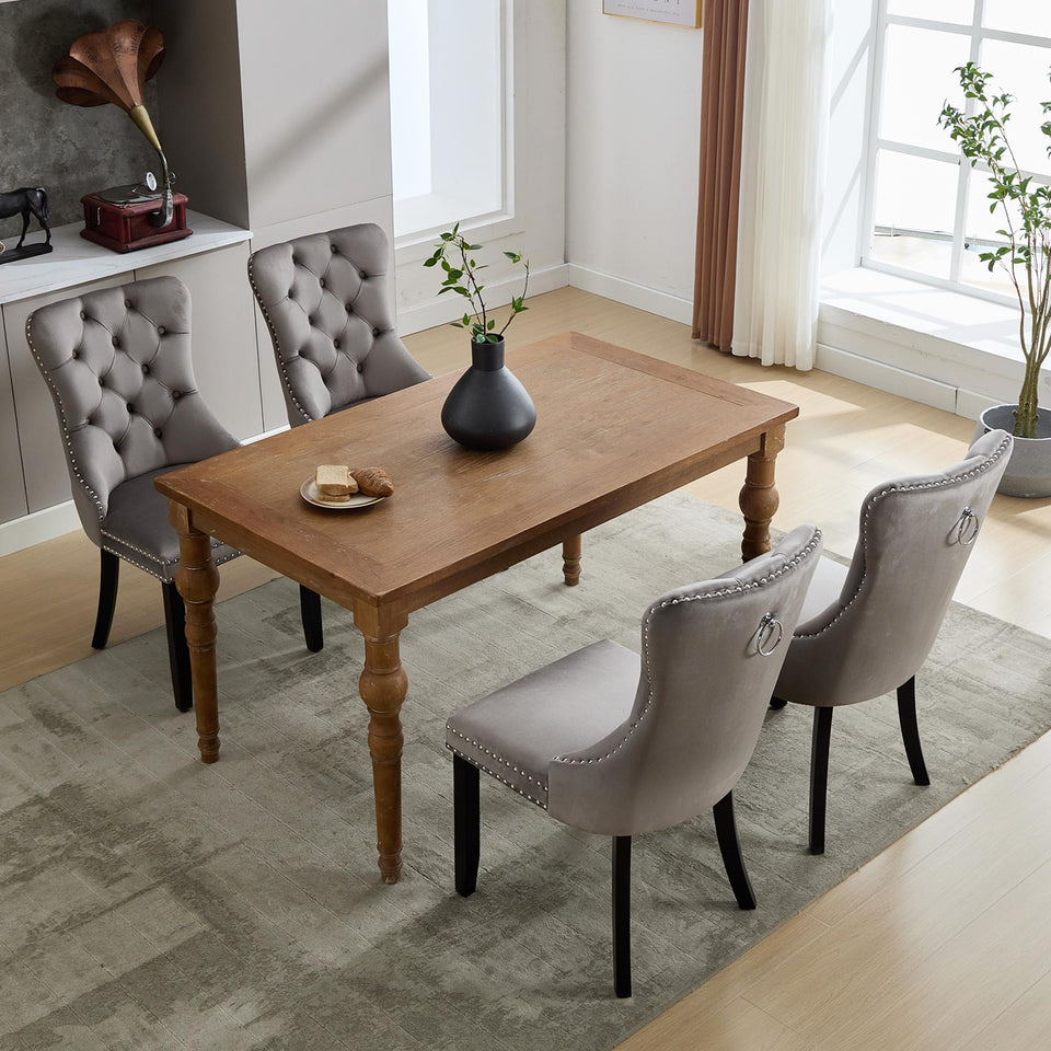 Set of 4 grey and beige velvet wingback dining chairs with button tufted backs and solid wood legs by Lavish Kitchen Isle.