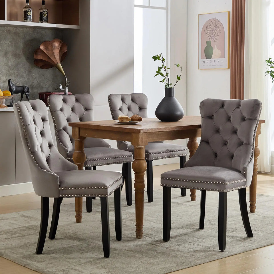 Set of 4 grey and beige velvet wingback dining chairs with button tufted backs and solid wood legs by Lavish Kitchen Isle