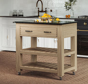 Baumhaus oak kitchen island with two drawers, black granite top, and brake wheels, showcasing a functional design.