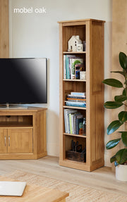 Tall narrow solid oak bookcase by Baumhaus with multiple shelves, showcasing contemporary storage design and natural wood finish.