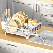 Stainless steel dish drying rack with drip tray and utensil holder, white color, for drying dishes and kitchenware.