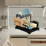 Black 2-tier dish drainer rack with drainage spout, utensil and cutting board holders, ideal for kitchen counters.