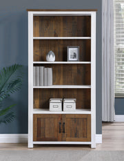Large white open bookcase with doors by Baumhaus, showcasing shelves and storage in a modern design.