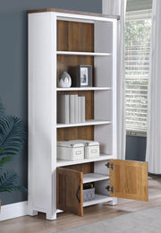 Large white open bookcase with doors by Baumhaus, featuring shelves and a sleek design, perfect for storage and display.