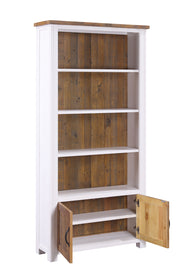 Large white open bookcase with doors by Baumhaus, showcasing multiple shelves and a sleek design in a bright room.