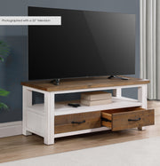Baumhaus white widescreen television cabinet with open shelves and sleek design in a modern living room setting.
