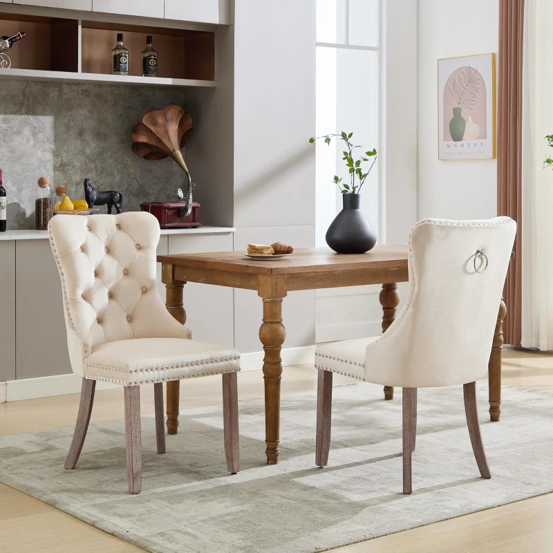 Set of 4 grey and beige velvet wingback dining chairs with button tufted backs and solid wood legs, by Lavish Kitchen Isle.