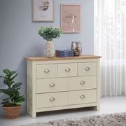 Cream chest of 7 drawers bedroom furniture with oak effect top and steel handles, by Lavish Kitchen Isle.