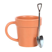 Ceramic mug with plant pot design and a matching shovel-shaped spoon from Lavish Kitchen Isle, ideal for gardening enthusiasts.