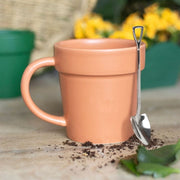 Plain ceramic plant pot mug with matching shovel spoon, ideal for gardening-themed kitchen decor. Lavish Kitchen Isle product.