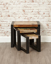 Urban Chic Nest of Tables by Baumhaus with a sleek design and rich wood finish, arranged in a modern living space.